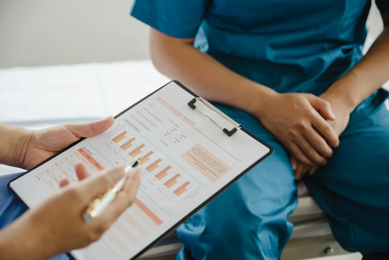 A doctor capturing patient-reported outcomes on a tablet