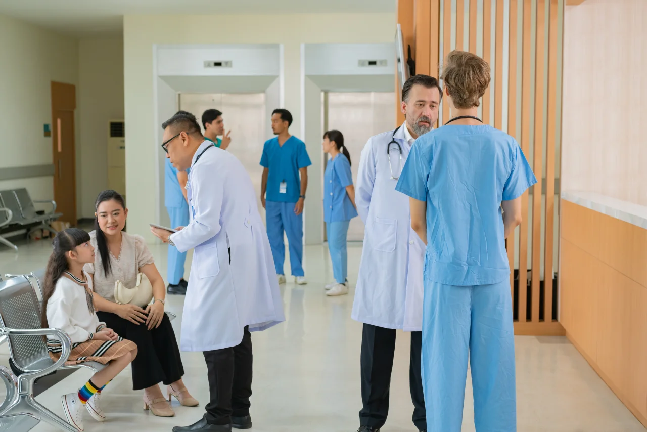A doctor supporting their elderly patient