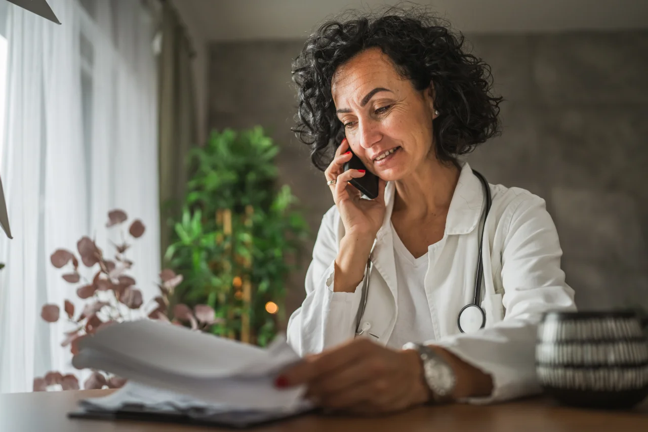 A doctor on the phone following up with a patient