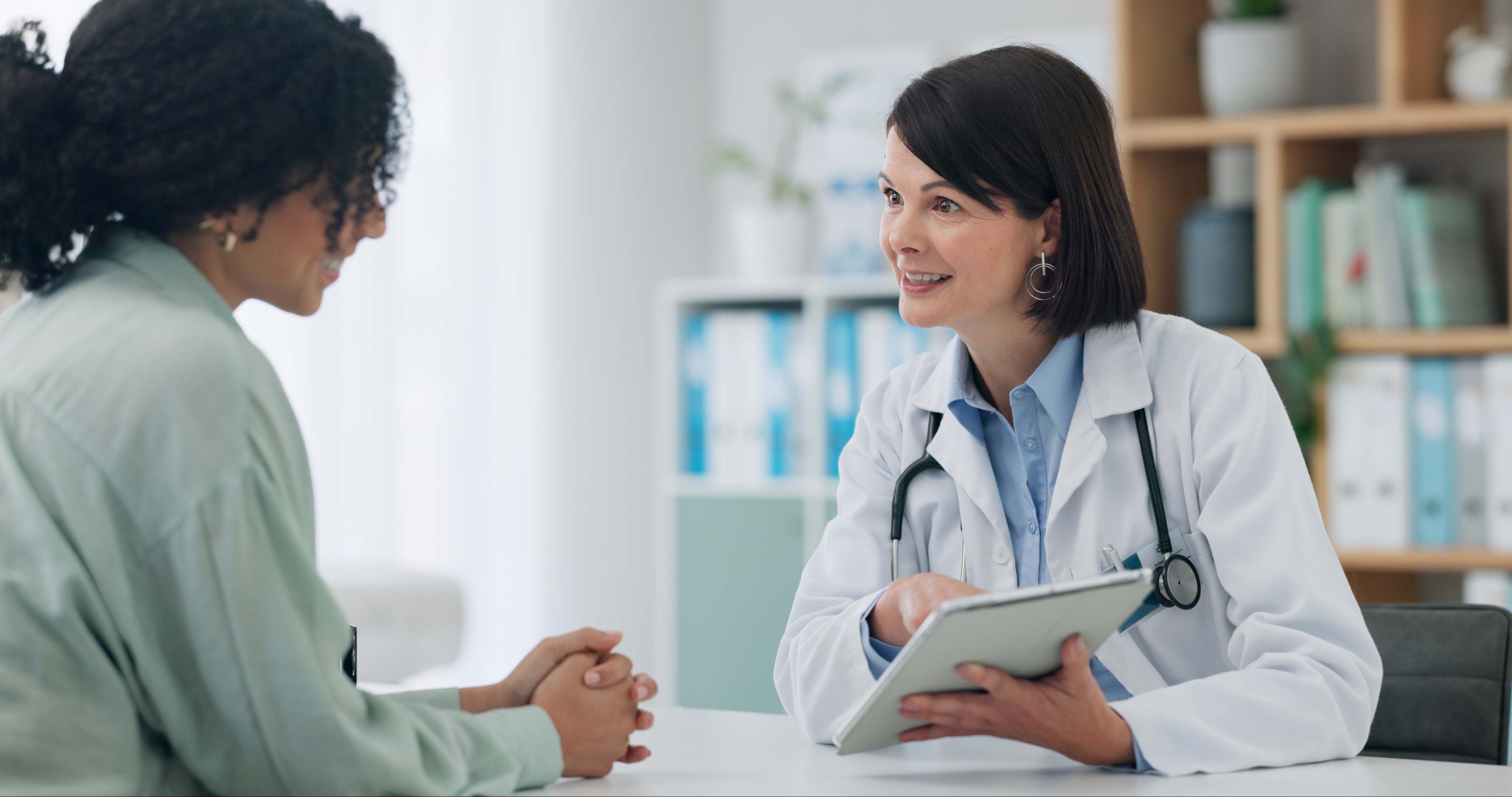 A doctor supporting their elderly patient